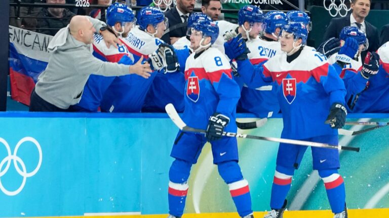 Slovakia's Oliver Okuliar (8) and Slovakia's Dalibor Dvorsky (15) celebrate their side's third goal during a men's ice hockey quarterfinal game between Slovakia and Germany at the 2026 Winter Olympics, in Milan, Italy, Wednesday, Feb. 18, 2026. (Petr David Josek/AP)