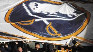 Boston Bruins fans assist in passing around a large Buffalo Sabres logo banner before the first period of an NHL hockey game in Buffalo, N.Y. on Saturday, Jan. 1, 2011. (Don Heupel/AP)