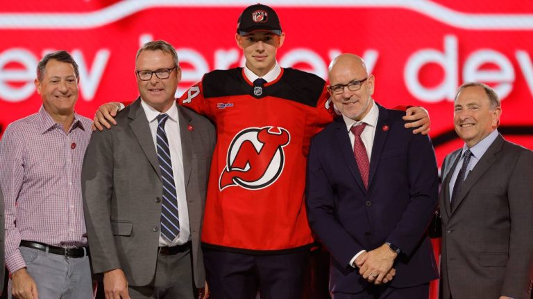 Anton Silayev, center, poses after being selected by the New Jersey Devils during the first round of the NHL hockey draft Friday, June 28, 2024, in Las Vegas. (Steve Marcus/AP)