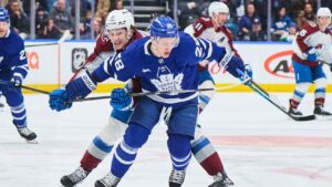 Colorado Avalanche's Taylor Makar (16) and Toronto Maple Leafs' Troy Stecher (28) battle for the puck during first period NHL hockey action. (Sammy Kogan/THE CANADIAN PRESS)