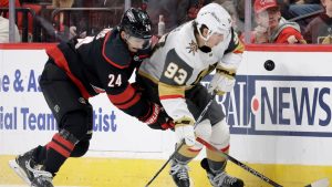 Carolina Hurricanes centre Seth Jarvis (24) and Vegas Golden Knights right wing Mitch Marner (93) go for the puck during the first period of an NHL hockey game, Oct. 28, 2025, in Raleigh, N.C. (Chris Seward/AP)