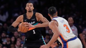 San Antonio Spurs' Victor Wembanyama, left, looks to pass around New York Knicks' Josh Hart (3) during the second half of an NBA basketball game Sunday, March 1, 2026, in New York. (Seth Wenig/AP)