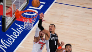 San Antonio Spurs forward Victor Wembanyama (1) shoots as New York Knicks guard Josh Hart (3) and center Karl-Anthony Towns (32) defend during the second half of Game 3 of the NBA Finals basketball series, Monday, June 8, 2026, in New York. (Yuki Iwamura/AP)
