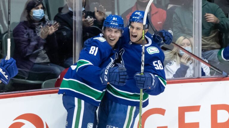 Vancouver Canucks' Chase Wouters (81) and William Lockwood (58) celebrate Wouters' goal against the Calgary Flames during the first period of a pre-season NHL hockey game in Abbotsford, B.C., Monday, Sept. 27, 2021. (Darryl Dyck/CP)