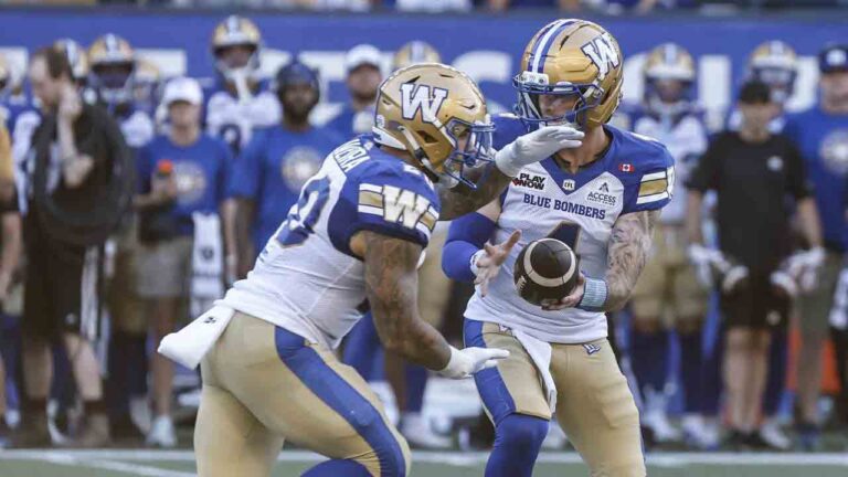 Winnipeg Blue Bombers quarterback Dru Brown (4) hands off to Brady Oliveira (20) during first half CFL football action against the Toronto Argonauts in Winnipeg on Friday, July 10, 2026. (John Woods/CP)