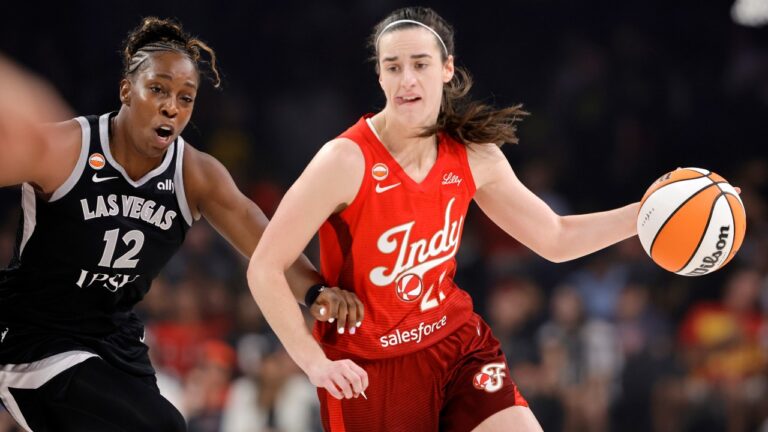 Indiana Fever guard Caitlin Clark (22) drives against Las Vegas Aces guard Chelsea Gray (12) during the first half of a WNBA basketball game Sunday, July 12, 2026, in Las Vegas. (Steve Marcus/Las Vegas Sun via AP)