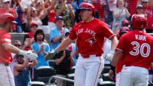 Toronto Blue Jays' Ernie Clement, left, and Alejandro Kirk congratulates Sean Keys after he hit a three run home run against the New York Mets during third inning MLB baseball action in Toronto on Wednesday, July 1, 2026. (Frank Gunn/CP)