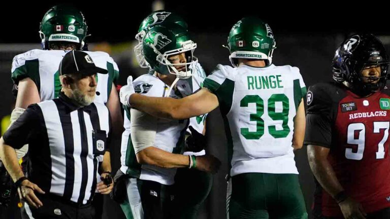 Saskatchewan Roughriders quarterback Trevor Harris (7) celebrates the team's win against the Ottawa Redblacks with Morgen Runge (39), during second half CFL football action in Ottawa on Friday, July 3, 2026. (Justin Tang/CP)