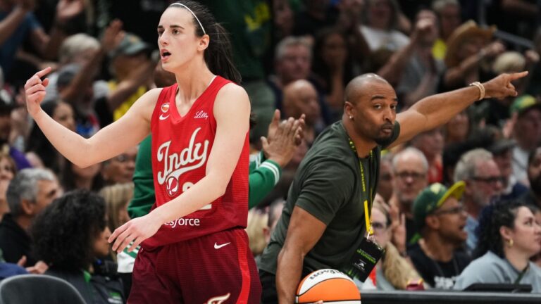 Indiana Fever guard Caitlin Clark points for possession as former Seattle Seahawks wide receiver Doug Baldwin, right, picks up the ball and calls for Seattle Storm possession during the first half of a WNBA basketball game, Tuesday, July 28, 2026, in Seattle. (Lindsey Wasson/AP)