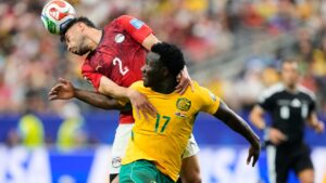 Egypt's Yasser Ibrahim (2) and Australia's Nestory Irankunda fight for the ball during the World Cup round of 32 soccer match in Arlington, Texas, near Dallas, Friday, July 3, 2026. (AP Photo/Tony Gutierrez)