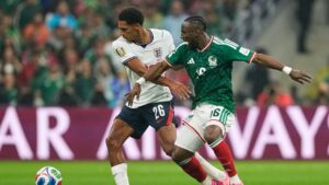 England's Jarell Quansah (26) and Mexico's Julian Quinones (16) battle for the ball during the World Cup round of 16 soccer match between Mexico and England in Mexico City, Sunday, July 5, 2026. (Natacha Pisarenko/AP)