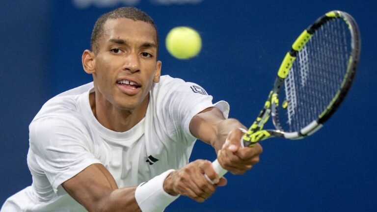Canada's Félix Auger-Aliassime lunges for a backhand return at the National Bank Open in Toronto on Wednesday, July 30, 2025. (Frank Gunn/CP)