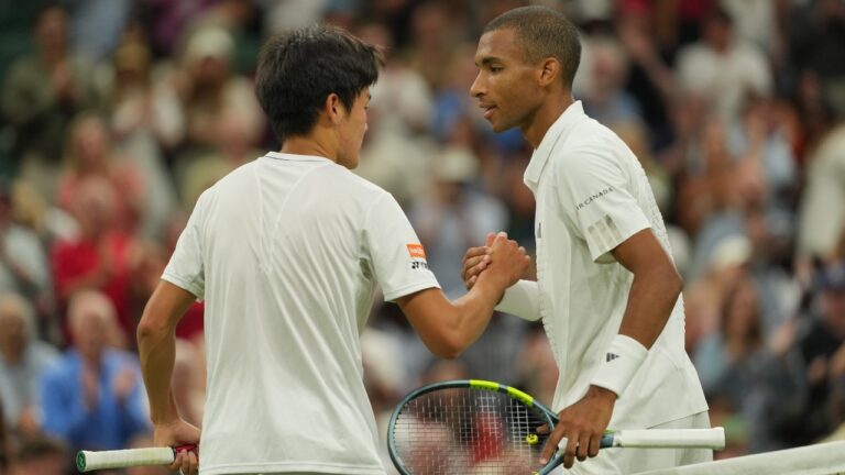 Felix Auger-Aliassime of Canada, right, shakes hands with Michael Zheng of the United States after beating him in their third round men's singles match at the Wimbledon Tennis Championships in London, Friday, July 3, 2026. (Kin Cheung/AP)