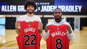 Toronto Raptors 2026 draft picks Allen Graves, left, and Jaden Bradley pause for a photo with their jerseys in Toronto on Thursday, June 25, 2026. THE CANADIAN PRESS/Sammy Kogan