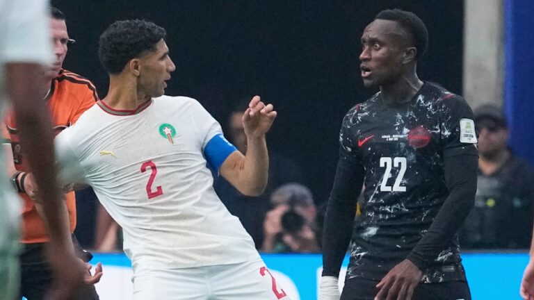 Canada's Richie Laryea tussles with Morocco captain Achraf Hakimi during the World Cup Round of 16 match. (David J. Phillip/AP)