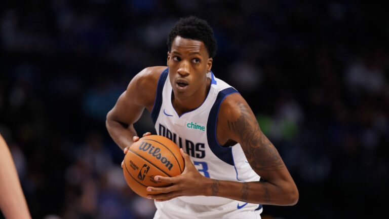 Dallas Mavericks center Jamarion Sharp (33) looks to pass during an NBA preseason basketball game against the Memphis Grizzlies in Dallas, Monday, Oct. 7, 2024. (AP Photo/Gareth Patterson)