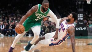 Boston Celtics guard Jaylen Brown (7) drives to the basket against Philadelphia 76ers forward Paul George (8) during the first half of Game 2 of a first-round NBA playoffs basketball series, Tuesday, April 21, 2026, in Boston. (AP Photo/Charles Krupa)