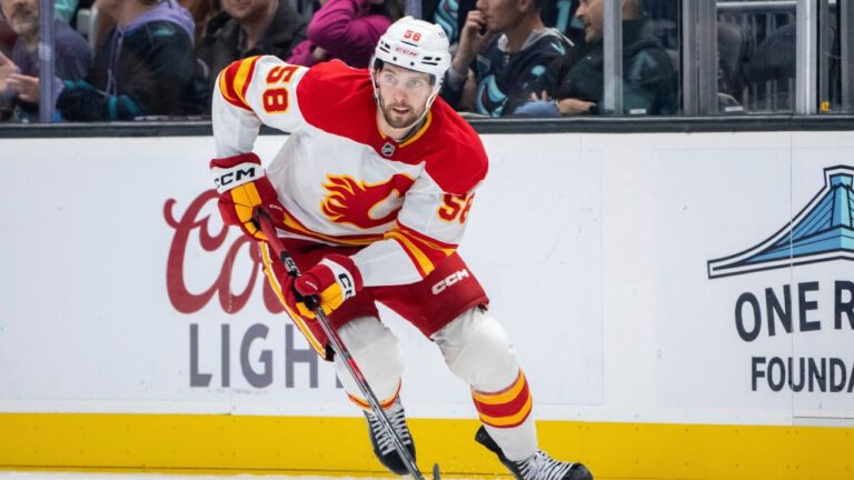Calgary Flames forward Justin Kirkland skates with the puck during an NHL hockey game against the Seattle Kraken, Saturday, Oct. 19, 2024, in Seattle. The Kraken won 2-1 in overtime. (Stephen Brashear/AP)