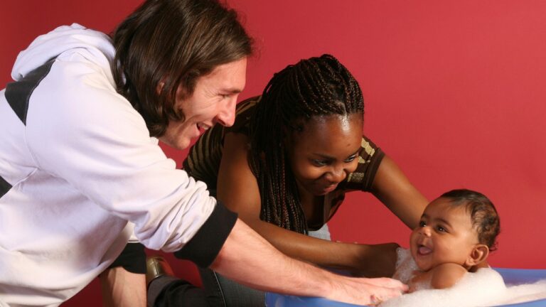 20-year-old soccer star Lionel Messi helps to bathe Lamine Yamal, who was merely six months old at the time with Yamal's mother Sheila Ebana during a photo session in Sept. 2007 in the dressing room of the Camp Nou stadium in Barcelona, Spain. (AP Photo/Joan Monfort)