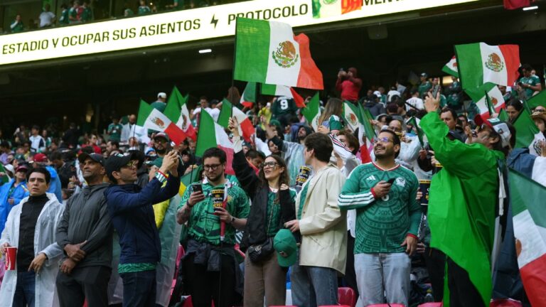 Video banners show weather warnings during the delayed start of the World Cup round of 16 soccer match between Mexico and England in Mexico City, Sunday, July 5, 2026. (Moises Castillo/AP)