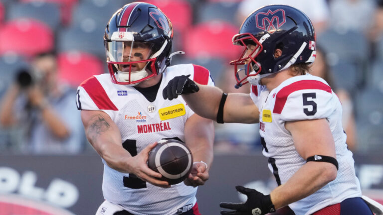 Montreal Alouettes quarterback Davis Alexander (10) hands the ball off to running back Travis Theis (5) during first half CFL action against the Ottawa Redblacks in Ottawa, Friday, July 31, 2026. (Adrian Wyld/CP)