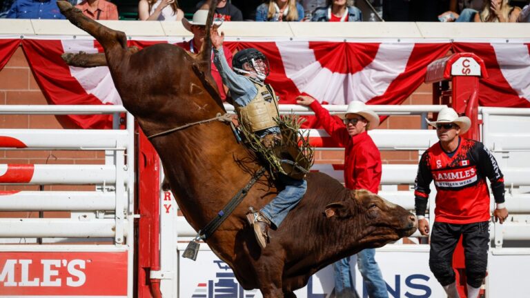 Noah Lee, of Mineral Wells, Texas, rides Whiskey At Noon to win the bull riding event during rodeo finals action at the Calgary Stampede in Calgary, Alta., Sunday, July 12, 2026. (Jeff McIntosh/CP)