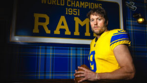 This undated photo provided by the Los Angeles Rams, Thursday, July 23, 2026, shows quarterback Matthew Stafford posing in Los Angeles wearing the Rams’ new “Classic Sol” alternate uniform. (Brevin Townsell/Los Angeles Rams via AP)