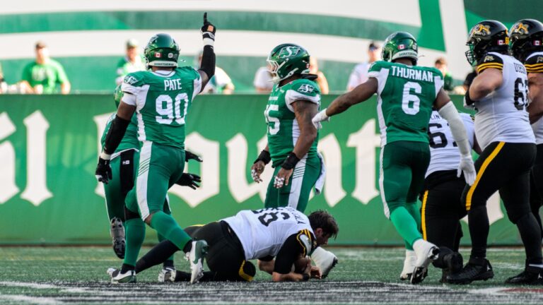 Saskatchewan Roughriders Jaylen Pate (90) sacks Tiger-Cats Jake Dolegala (16) during first half CFL football action in Regina, Sunday, July 12, 2026. (Derek Elvin/CP)