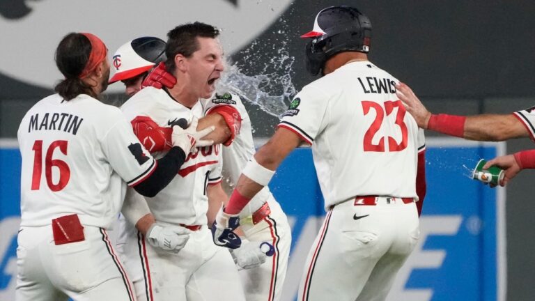 Minnesota Twins' Alan Roden, third from right, celebrates with teammates after hitting a walk-off RBI single scoring Royce Lewis in the ninth inning of a baseball game against the Cleveland Guardians, Wednesday, July 8, 2026, in Minneapolis. (AP Photo/Joseph Scheller)