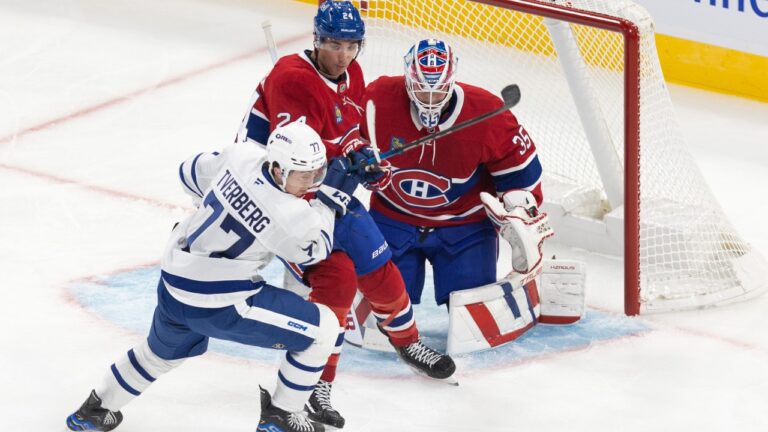 Toronto Maple Leafs' Ryan Tverberg (77) is tied up by Montreal Canadiens' Logan Mailloux (24) after a rebound was given up by goaltender Sam Montembeault (35) during first period NHL pre-season action in Montreal on Saturday, September 28, 2024. THE CANADIAN PRESS/Evan Buhler