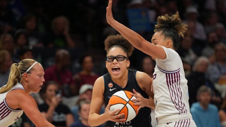 Minnesota Lynx guard Olivia Miles (5) drives around Toronto Tempo guards Kiki Rice (1) and Julie Allemand (22), left, in the first quarter of a WNBA basketball game Tuesday, July 28, 2026, in Minneapolis. (Jeff Wheeler/Minnesota Star Tribune via AP)