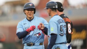 Toronto Blue Jays' Kazuma Okamoto, left, is congratulated by first base coach Mark Budzinski (53) after hitting a single during the third inning of a baseball game against the San Francisco Giants Tuesday, July 7, 2026, in San Francisco. (Jeff Chiu/AP)