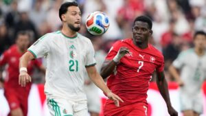 Algeria's Ramy Bensebaini (21) and Switzerland's Breel Embolo (7) battle for the ball during the World Cup round of 32 soccer match between Switzerland and Algeria in Vancouver, British Columbia, Thursday, July 2, 2026. (AP Photo/Lindsey Wasson)