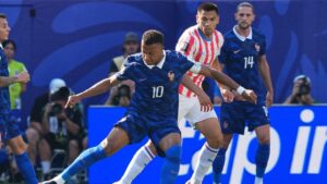 France's Kylian Mbappe (10) duels for the balls with Paraguay's Diego Gomez (8) during the World Cup round of 16 soccer match between Paraguay and France in Philadelphia, Saturday, July 4, 2026. (AP Photo/Martin Meissner)