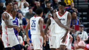 Washington Wizards' AJ Dybantsa, right, celebrates after a play against the Utah Jazz during the first half of an NBA Summer League basketball game Thursday, July 9, 2026, in Las Vegas. (AP Photo/John Locher)
