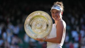 Linda Noskova of Czech Republic poses with the trophy after winning against Karolina Muchova of Czech Republic in the women's singles final at Wimbledon Tennis Championships in London, Saturday, July 11, 2026. (AP Photo/Kirsty Wigglesworth)