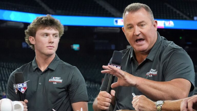 Landon Thome, left, a second and third baseman from Nazareth Academy, listens to his father, Jim Thome, an MLB Hall of Fame inductee, as he speaks at the MLB baseball combine in Phoenix, June 23, 2026. (AP Photo/Ross D. Franklin, File)