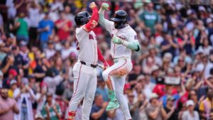 Boston Red Sox's Ceddanne Rafaela, right, is congratulated by Wilyer Abreu after hitting a solo home run in the fourth inning during the first baseball game of a doubleheader against the Baltimore Orioles, Wednesday, July 22, 2026, in Boston. (AP Photo/Charles Krupa)