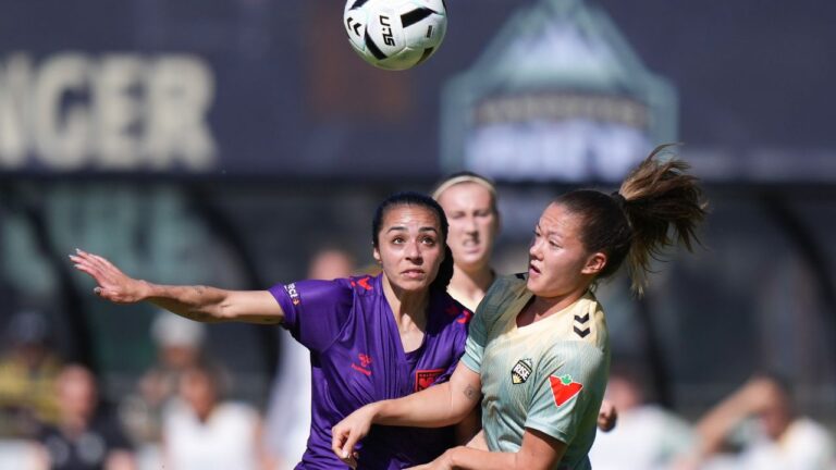 Calgary Wild's Jaclyn Sawicki, left, and Vancouver Rise's Samantha Chang during the first half of a match, in Burnaby, B.C., on Saturday, May 24, 2025. (Darryl Dyck/CP)