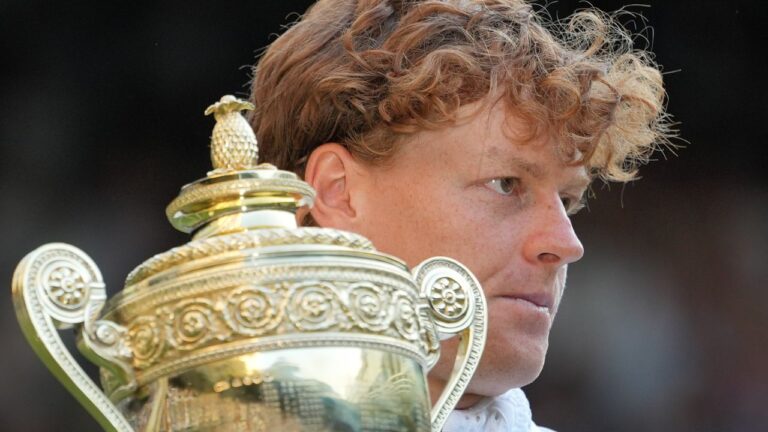 Jannik Sinner holds up the winners trophy after defeating Alexander Zverev of Germany in the men's singles final at the Wimbledon Tennis Championship in London, on Sunday, July 12, 2026. (Kin Cheung/AP)