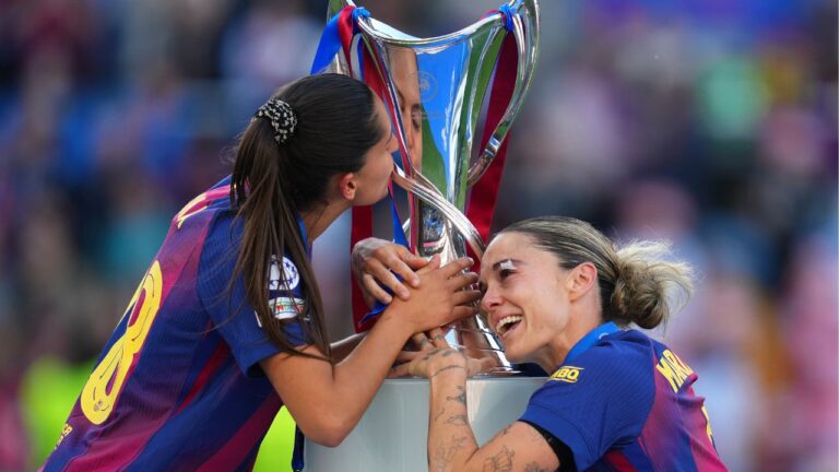 Kika Nazareth, left, and Mapi Leon touch the trophy after winning the Women's Champions League final between FC Barcelona and OL Lyonnes, in Oslo, Saturday, May 23, 2026. (Kirsty Wigglesworth/AP)
