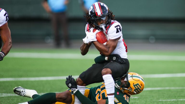 Edmonton Elks' Dariel Djabome (45) tackles Ottawa Redblacks' Kalil Pimpleton (83) during a game in Edmonton on Thursday, July 9, 2026. (Codie McLachlan/CP)