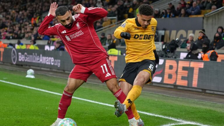 Joao Gomes (right) clears the ball as Mohamed Salah (left) challenges during an English Premier League soccer match between Wolverhampton Wanderers and Liverpool in Wolverhampton, England, on Tuesday, March 3, 2026. (Dave Shopland/AP)