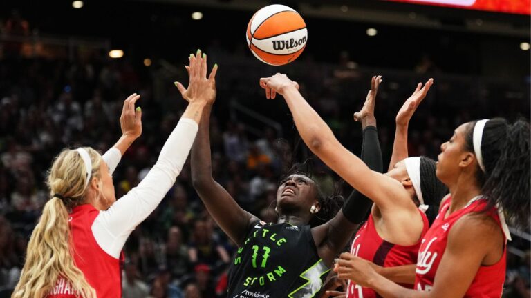 Seattle Storm centre Awa Fam (11) goes for the ball against Indiana Fever guard Sophie Cunningham, left, and forward Makayla Timpson, third from left, during the second half of a game on Tuesday, July 28, 2026, in Seattle. (Lindsey Wasson/AP)