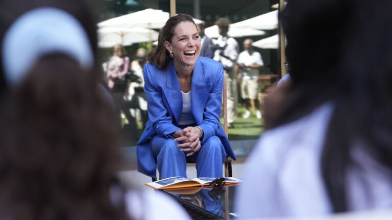 Britain's Kate, the Princess of Wales meets with children from Shine Camera Club, a creative photography programme based in the London Borough of Merton which supports children from disadvantaged backgrounds to develop confidence, creativity and self-expression through photography, during a visit on day four of the Wimbledon Tennis Championships in London, Thursday, July 2, 2026. (AP Photo/Andrew Matthews)