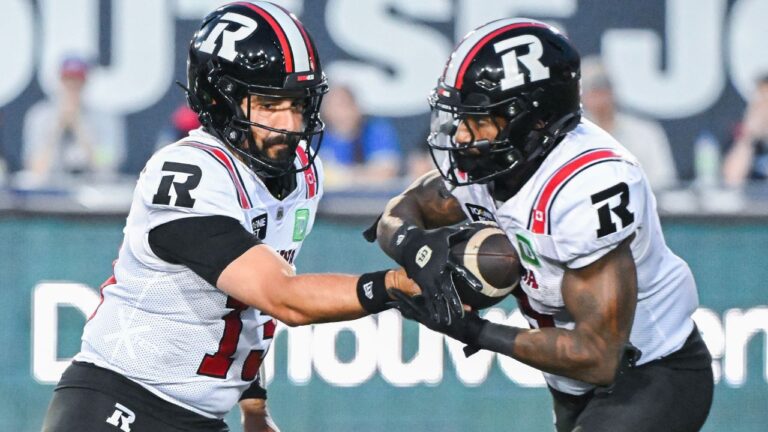 Ottawa Redblacks quarterback Jake Maier hands off to Greg Bell during second half against the Montreal Alouettes in Montreal on Sunday, June 28, 2026. (Graham Hughes/CP)