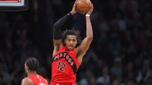 Toronto Raptors forward Collin Murray-Boyles (12) grabs a rebound in the first half of an NBA basketball game against the Boston Celtics, Sunday, April 5, 2026, in Boston. (AP Photo/Steven Senne)