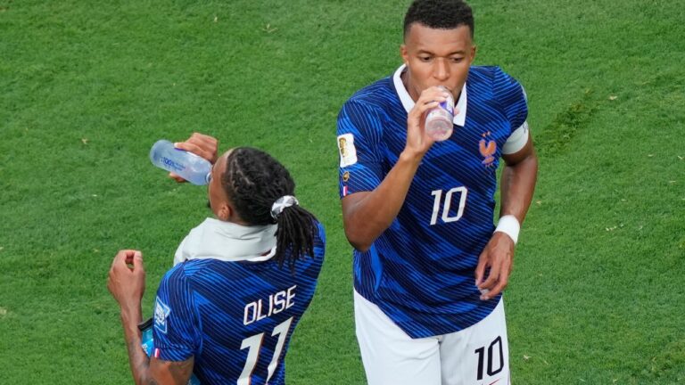 France's Kylian Mbappe and Michael Olise during a hydration break during the World Cup match between France and Sweden in East Rutherford, N.J., near New York on Tuesday, June 30, 2026. (Yuki Iwamura/AP)