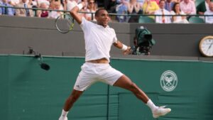 Felix Auger-Aliassime of Canada jumps to play a return during the men's singles fourth round match against Alejandro Davidovich Fokina of Spain at the Wimbledon Tennis Championships in London, Sunday, July 5, 2026.(AP Photo/Kin Cheung)
