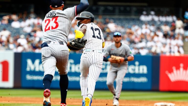 New York Yankees' Jazz Chisholm Jr.(13) tries to avoid being tagged out by Minnesota Twins' Royce Lewis (23) during a rundown in the second inning of a baseball game, Sunday, July 5, 2026, in New York. (AP Photo/Noah K. Murray)